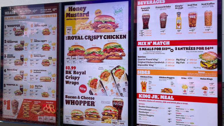 A POS at a KFC with signs of their special menu for Oven Roasted Strips Combo showing its calorie count