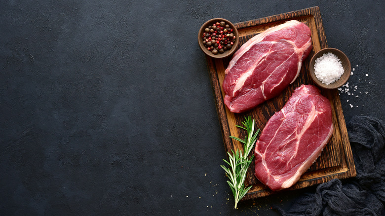 Two steaks on a cutting board