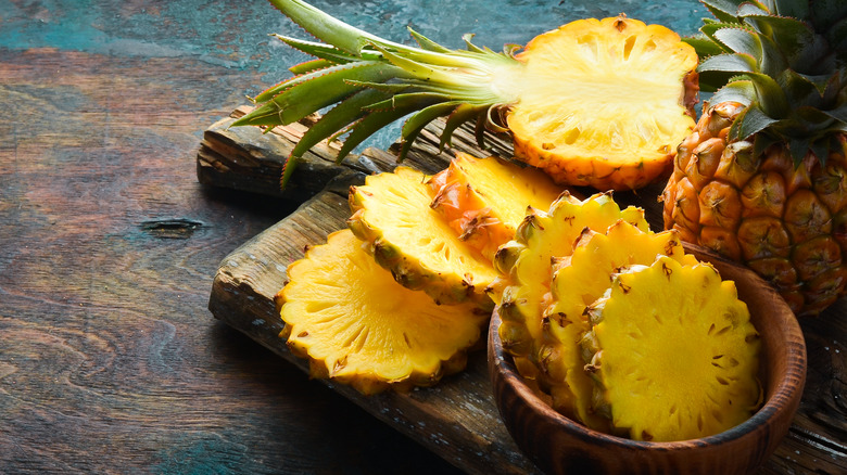 Sliced pineapple on board