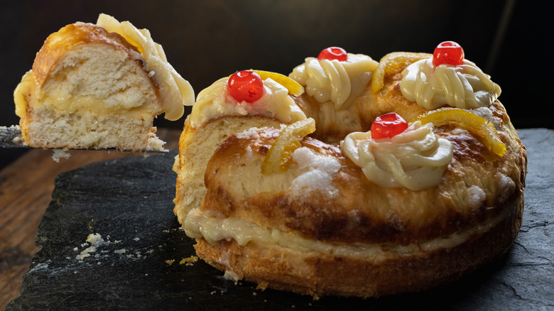 Rosca de Pascua Easter cake filled with cream and topped with icing and cherries