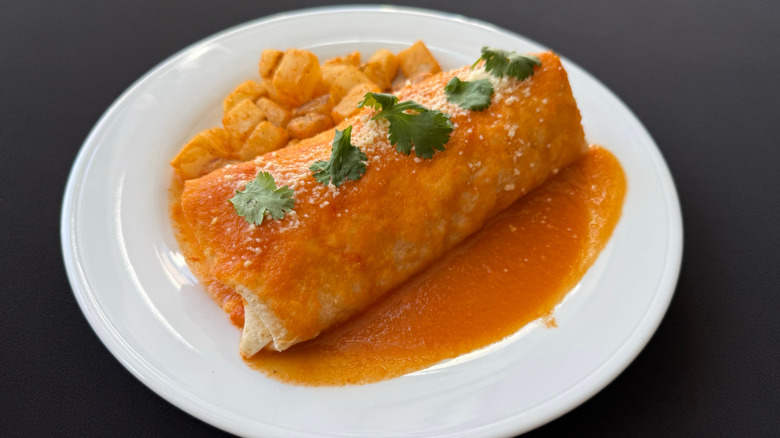 A breakfast burrito smothered in green chili in Denver