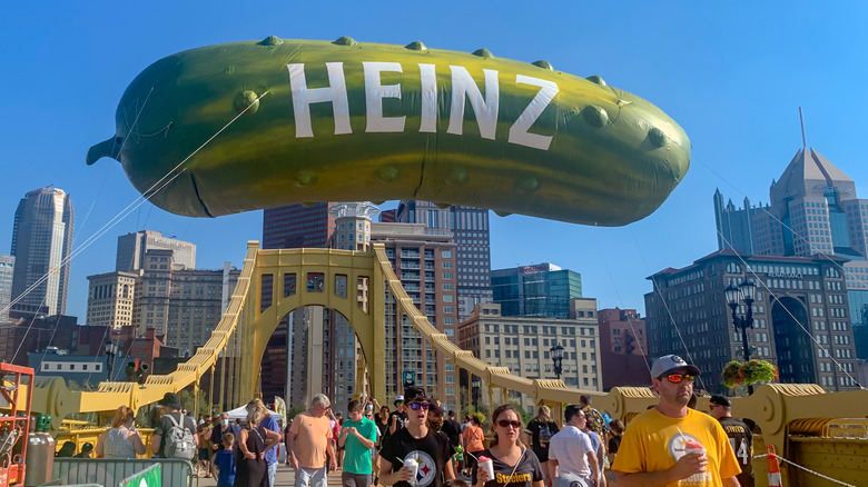 The Heinz pickle float above a crowded bridge at Picklesburgh
