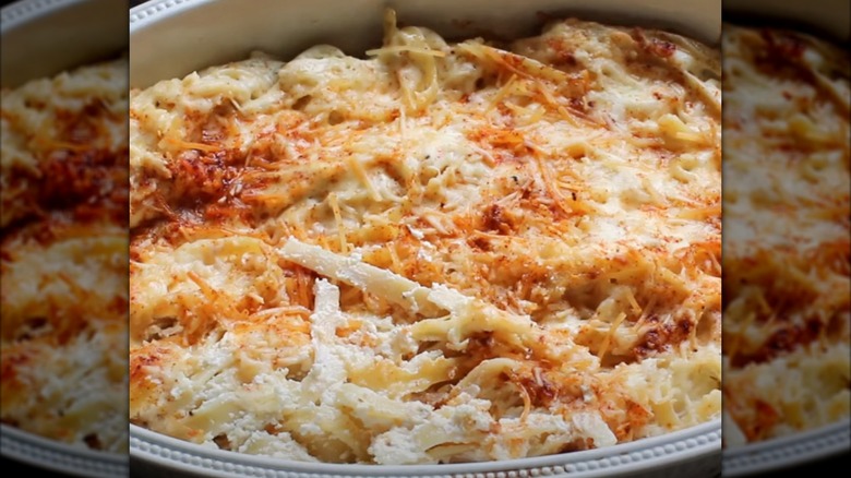 up close shot of melted noodles romanoff with a crispy cheese topping