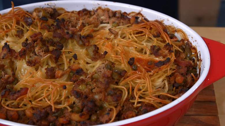 bowl of spaghetti mixed with ground beef, peppers and tomatoes