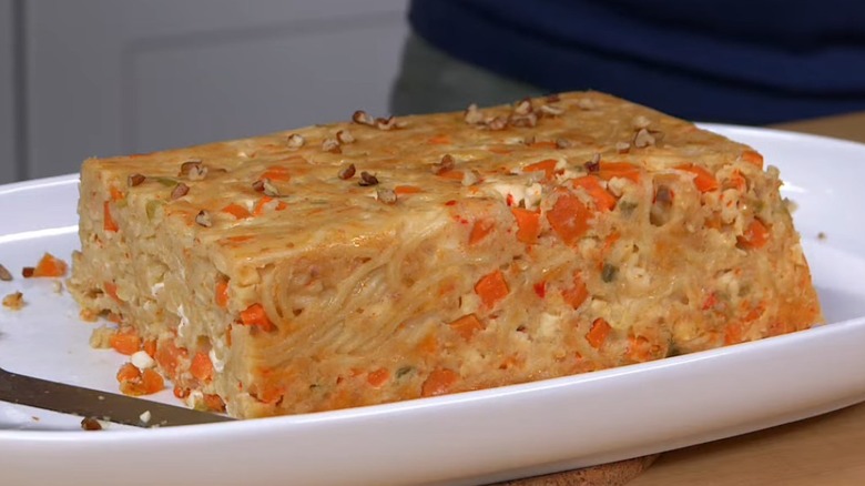 baked spaghetti aquitania pasta on a white plate