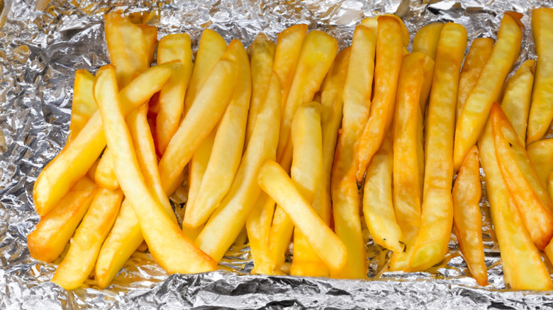 Grilled french fries in aluminum foil
