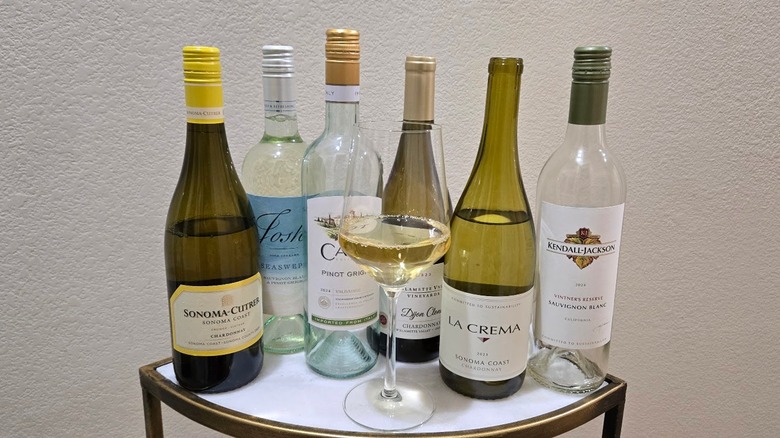 Group of white wines available at Sam's Club with a glass of wine