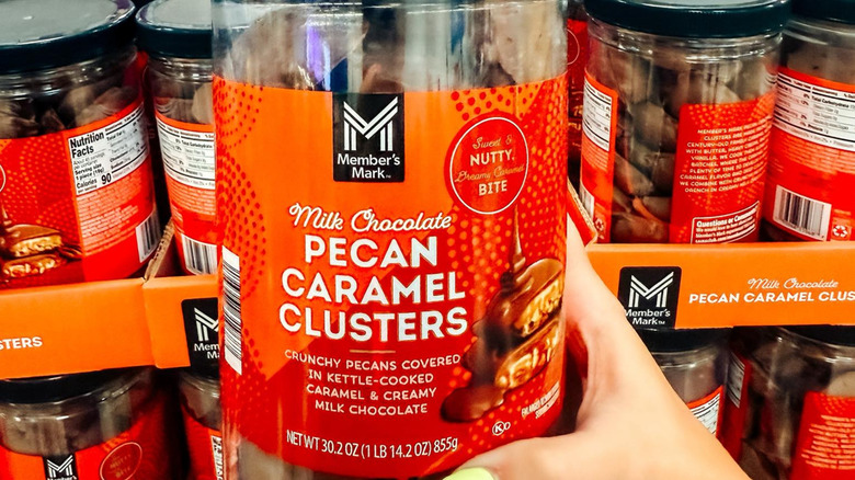 woman holding Members Mark pecan clusters