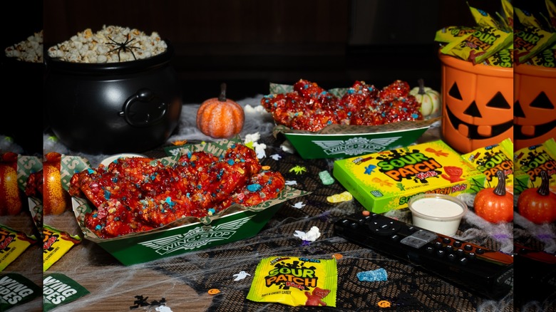 Wingstop Sour Patch Kids Wicked Punch Wings on a table near Halloween candy