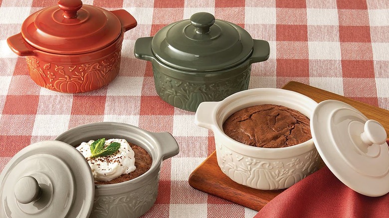 A miniature bakeware set on a checked table cloth.
