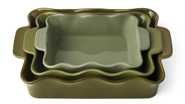 Green bakeware set with wavy edge designs and handles.