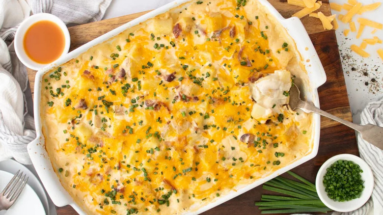 Potato casserole topped with cheese and chives