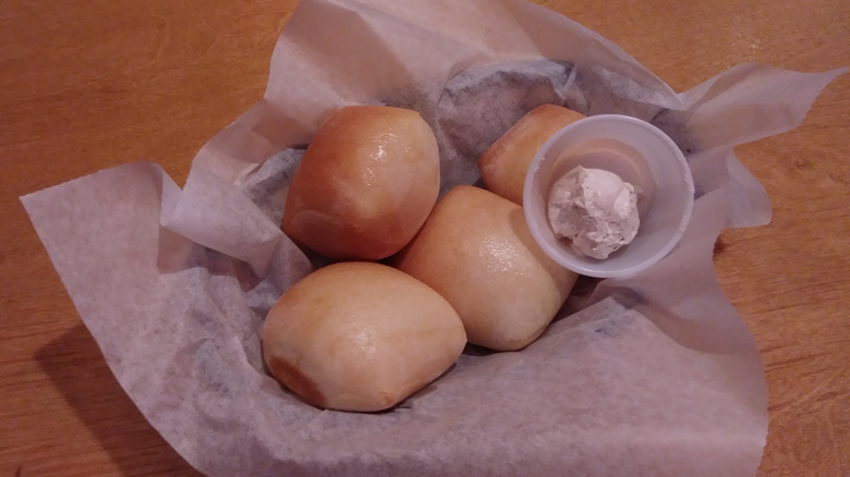 Texas Roadhouse rolls with butter in basket