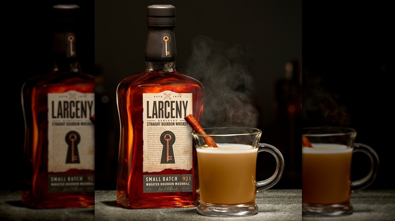Bottle of Larceny Small Batch with hot cocktail in glass mug