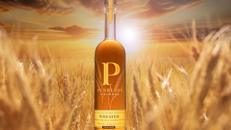 Penelope wheated Bourbon bottle on background of wheat field