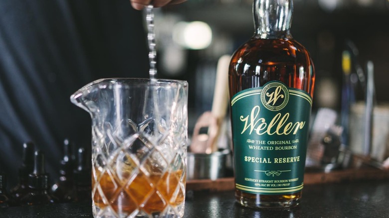Bottle of Weller Special Reserve on bar with blurred glass in foreground