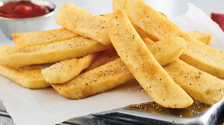 A close-up of steak fries with a side of ketchup at Red Robin