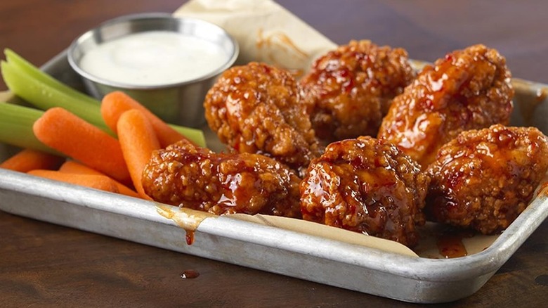 Close-up of a tray of Buffalo Wild Wings with crudité and dipping sauce