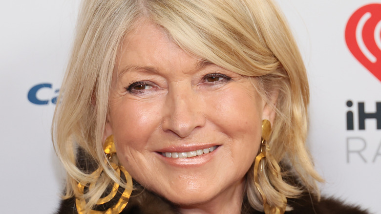 Martha Stewart smiles with gold earrings