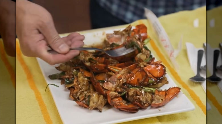 Fork takes a bite from a dish of seared lobster shells with veggies at Pagoda Chinese Restaurant