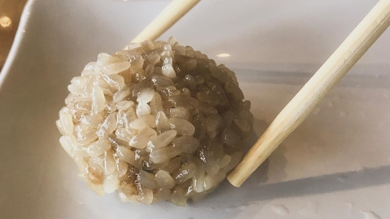 Close up of rice dumpling between chopsticks from Hello Dumpling restaurant