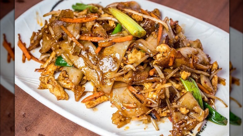 Close up of How Fun noodle dish with veggies and pieces of meat in sauce from KungFood Chu restaurant