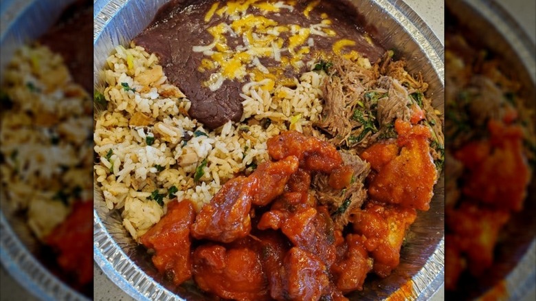 Jade red chicken bowl with rice and refried beans from Chino Bandido restaurant