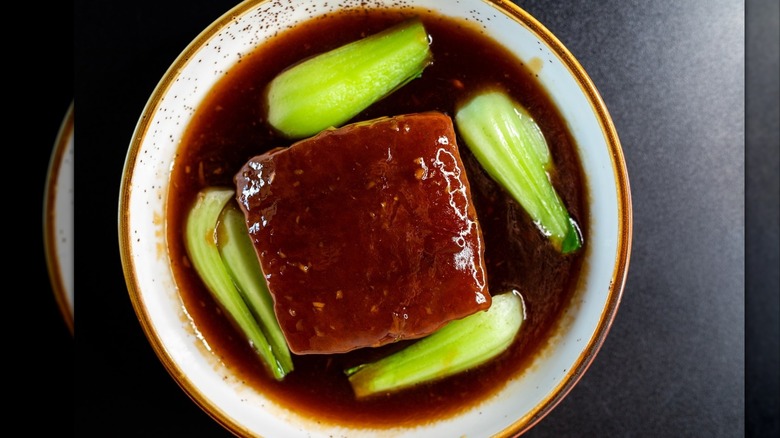 Sichuan pork belly dish in plate with broth and leeks at Sichuan House restauant