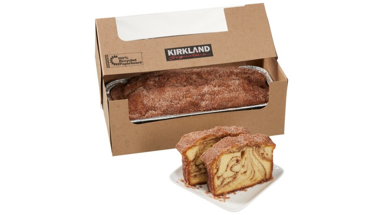 Dessert loaf topped with cinnamon sugar with two slices on a white plate in the front