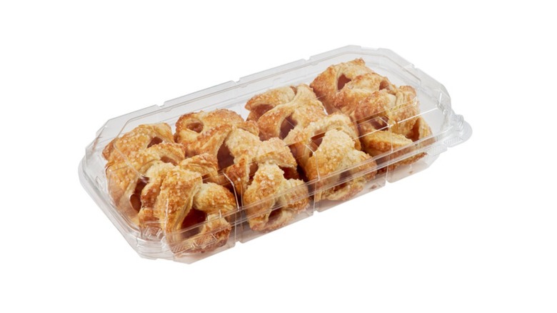 Apple pie bites in a plastic clamshell container on a white background