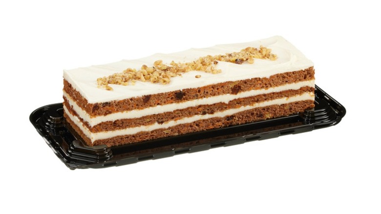 Picture of a carrot cake on black platter on a white background