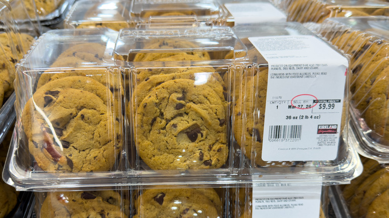 Costco chocolate chunk cookies in plastic clamshell containers on a store shelf