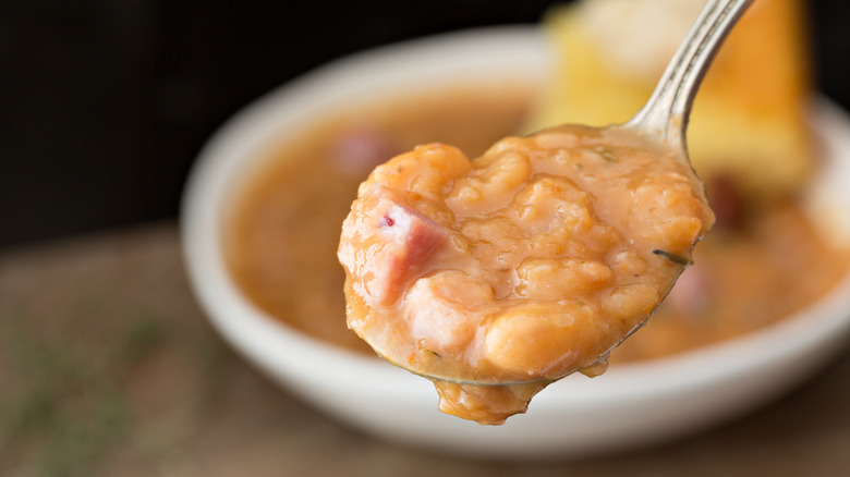 close-up of bean and ham soup on a spoon