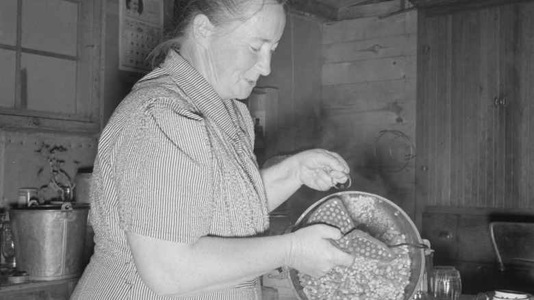 woman cooking pot of food during Great Depression