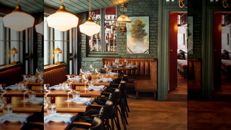 The interior of Joe Beef in Montreal showing set wooden tables
