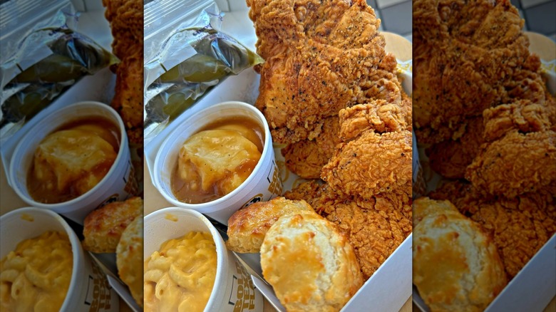 Conatiner of mac n cheese, mashed potatoes, biscuits, and fried chicken