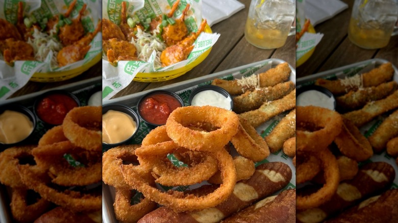 Tray of fried starters alongside a basket of chicken wings