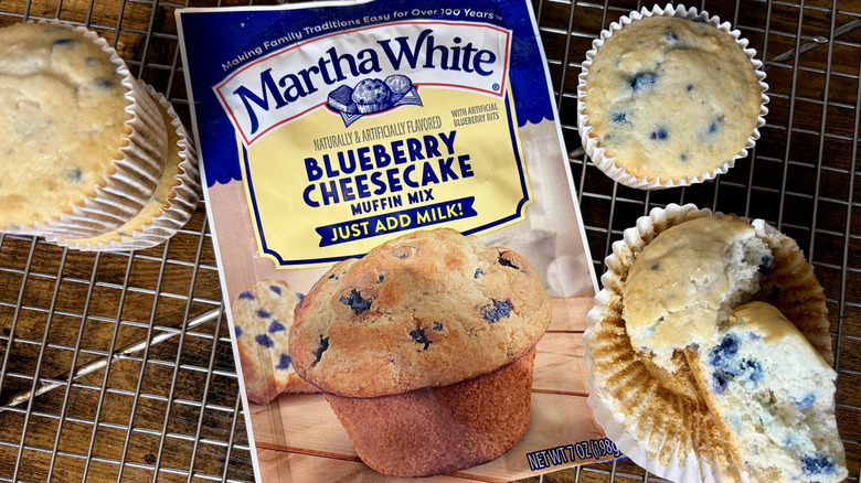 A package of Martha White Blueberry Cheesecake Muffin Mix and baked muffins