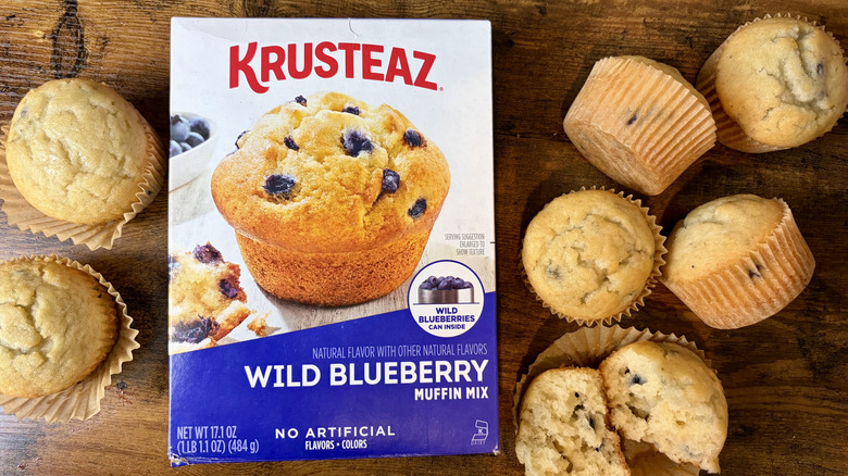 A box of Krusteaz Wild Blueberry Muffin Mix and baked muffins
