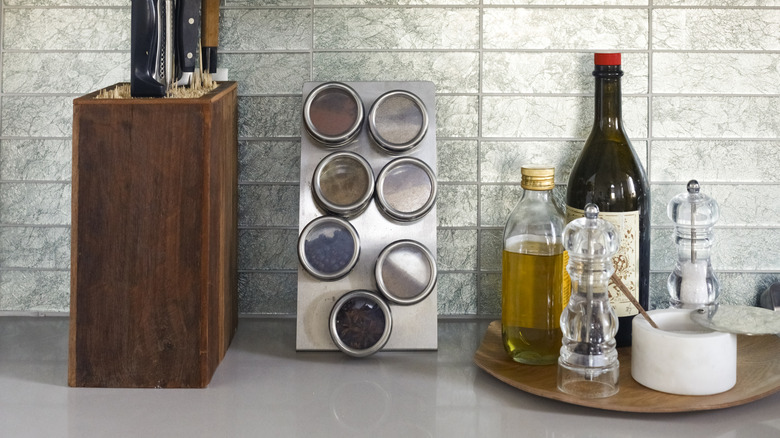 olive oil, salt, pepper, and spices on kitchen counter