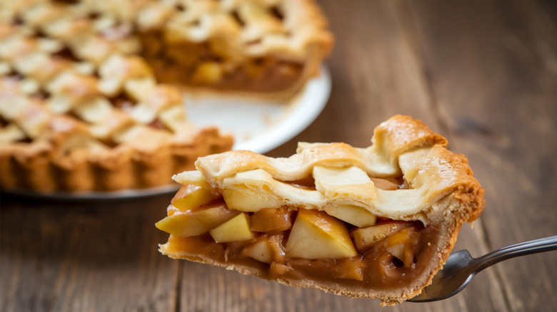 slice of apple pie being lifted out of dish