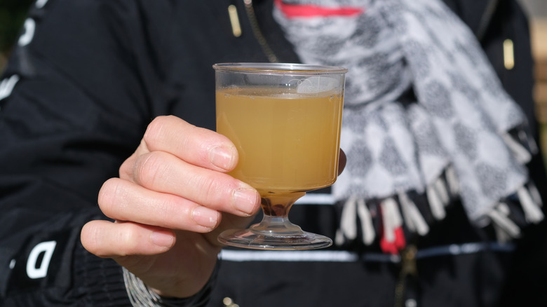 hand holding a glass of mead