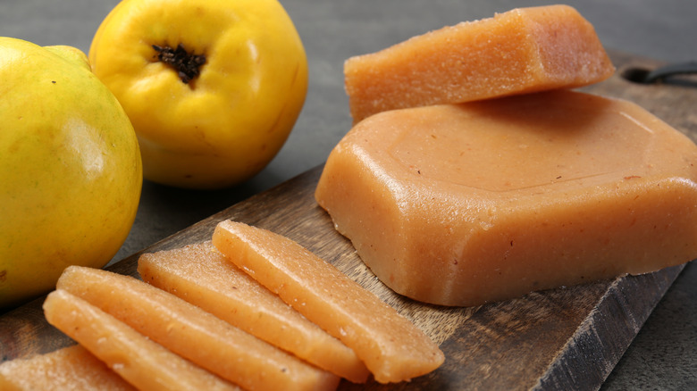 slices of quince paste next to whole quinces