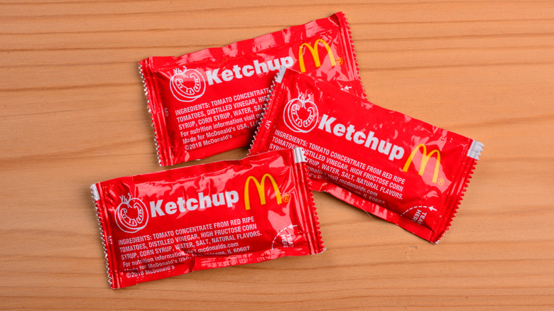 McDonald's ketchup packets on wooden surface