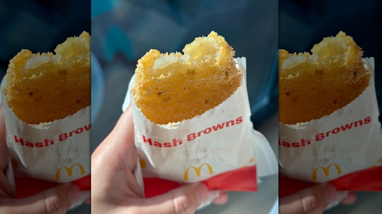 Hand holding an extra-crispy McDonald's hash brown