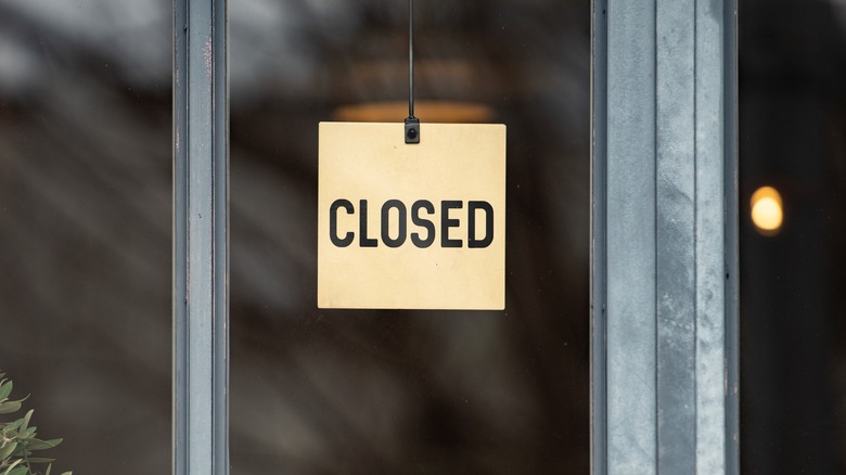 Closed sign hanging on a restaurant window