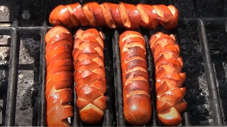 Crosshatch cut sausages on grill