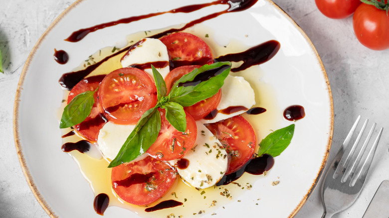 Balsamic vinegar drizzled over caprese salad