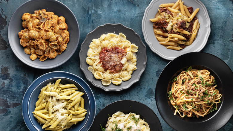 An array of pasta dishes on a rustic table
