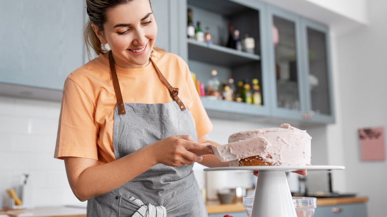 person frosting cake